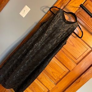 AMAZING black dress.  The sequin detail is in a leather like material!